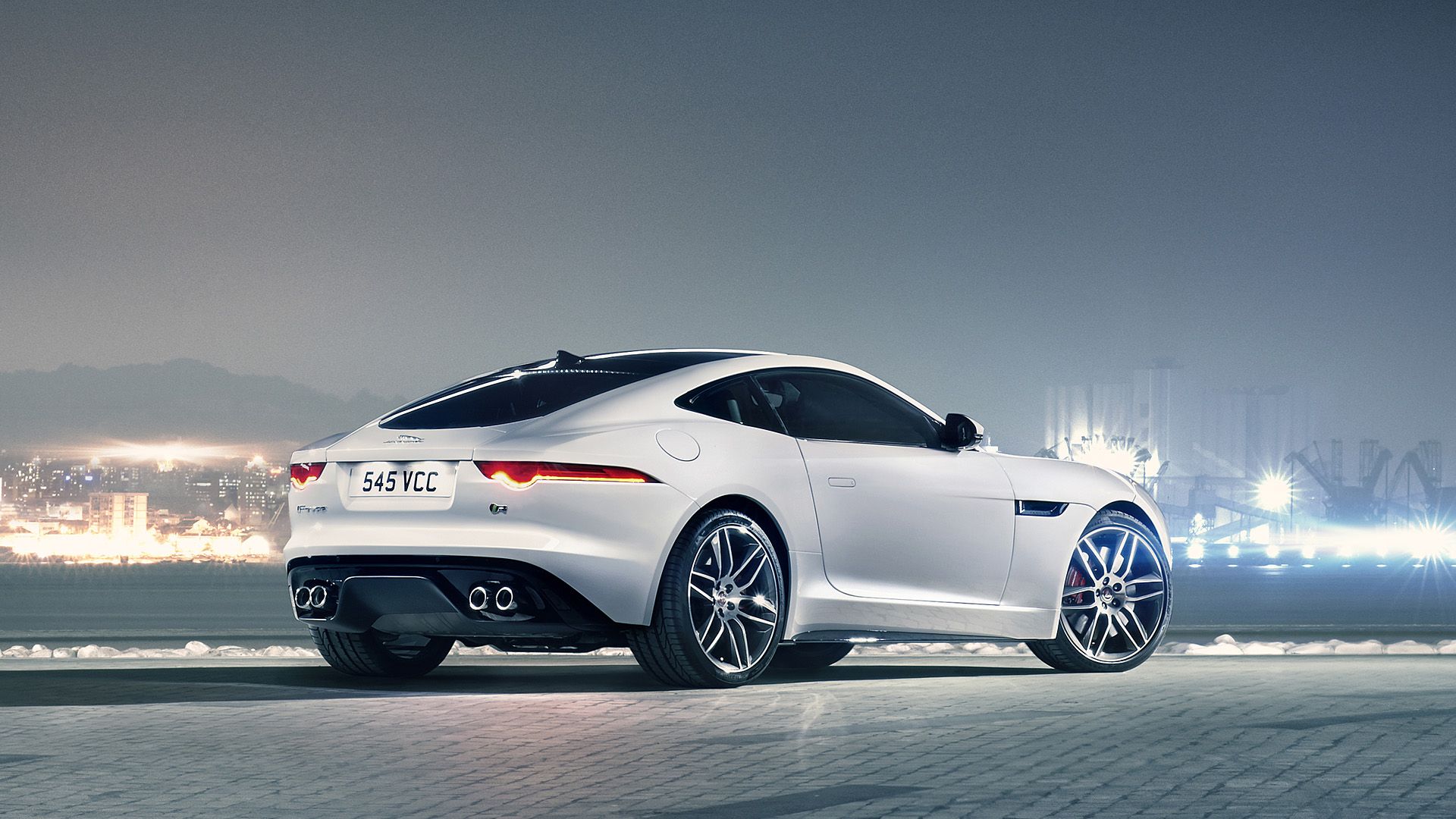 Silver sports car beside the water